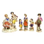 Group of Continental porcelain figures including a group with seated lady and sheep by her side,