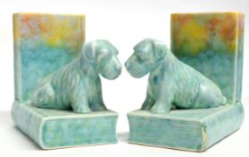 Pair of Art Deco pottery bookends both shaped with terriers seated on books