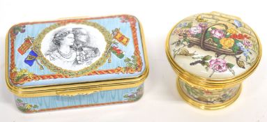 Two Halcyon Days enamel boxes in original packaging, one with a quotation from Voltaire, the
