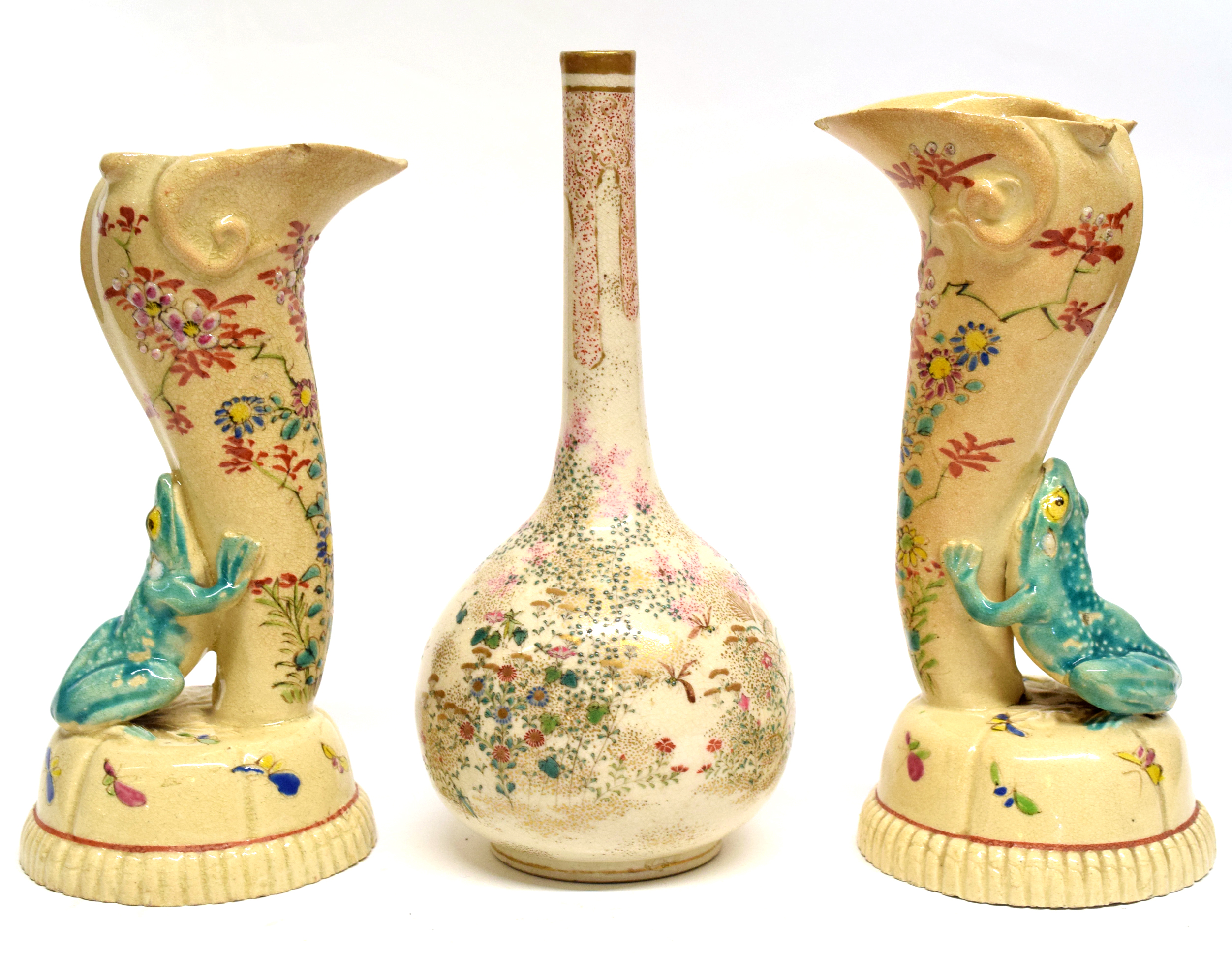 Pair of Japanese earthenware vases, flanked by frogs in green, together with a Satsuma bottle