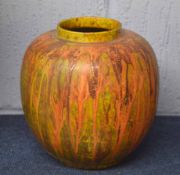 Unusual pottery ginger jar with a streaked orange design on a mottled green ground, 23cm high