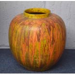 Unusual pottery ginger jar with a streaked orange design on a mottled green ground, 23cm high