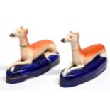 Two Staffordshire models of pen holders modelled as greyhounds