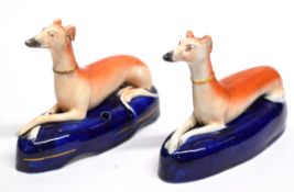 Two Staffordshire models of pen holders modelled as greyhounds