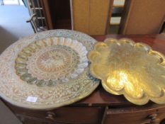 ORNATELY INSCRIBED BRASS TRAY OF INDIAN ORIGIN, TOGETHER WITH A SIMILAR FLOWER SHAPED TRAY, LARGER