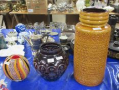 LARGE WEST GERMAN POTTERY VASE TOGETHER WITH A GLASS VASE, THE PURPLE GROUND WITH FLORAL