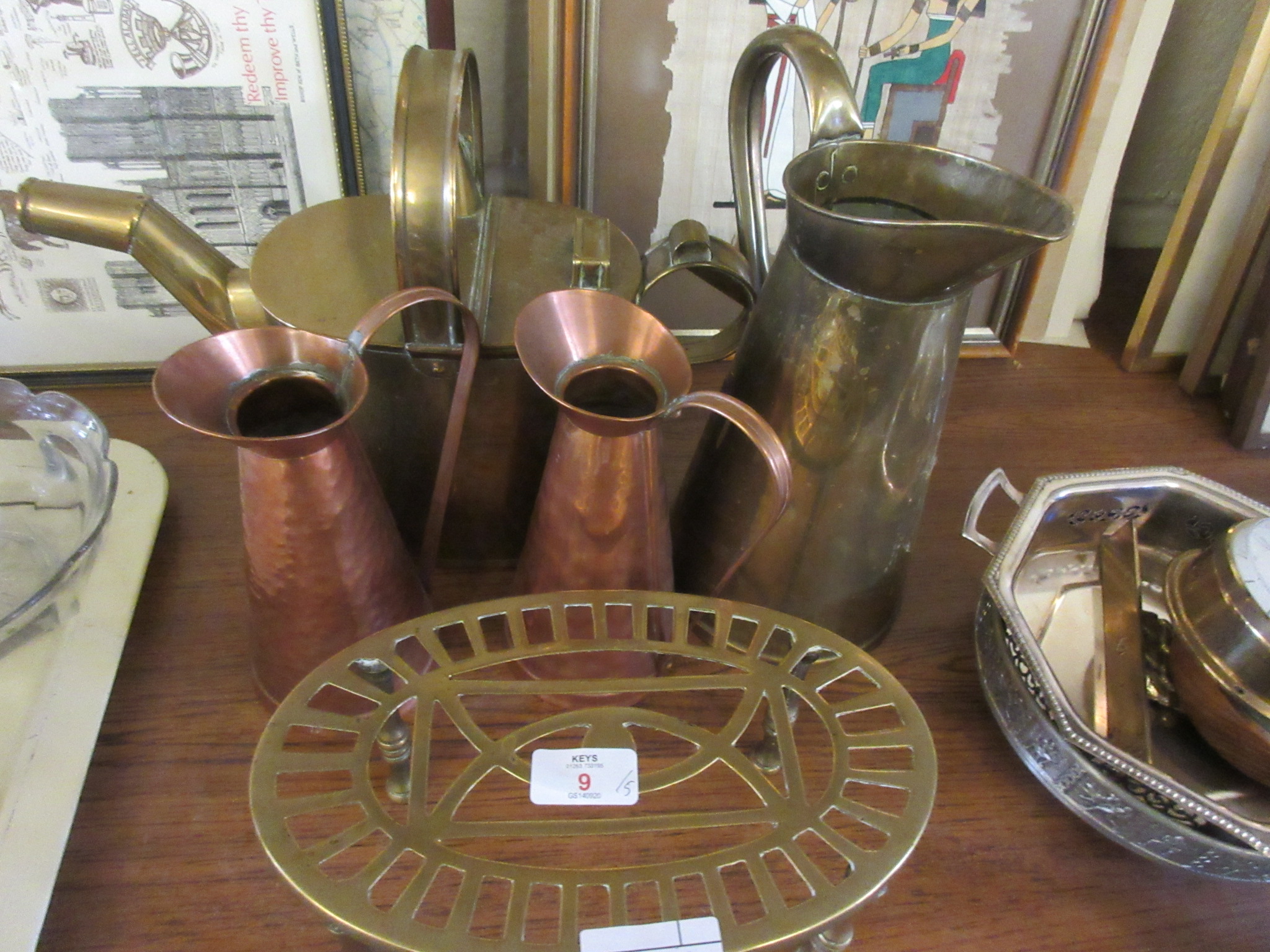 VARIOUS METAL WARE COMPRISING TRIVET, THREE WATER JUGS AND A WATER CAN