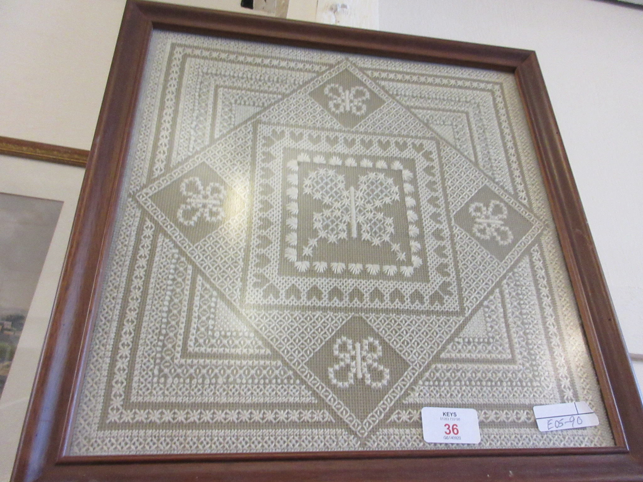 FRAMED DECORATIVE NEEDLEPOINT, GEOMETRIC PATTERN SURROUNDING A CENTRAL PANEL DEPICTING A