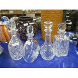 GROUP OF FOUR CUT GLASS DECANTERS WITH MATCHING STOPPERS