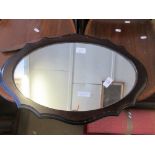 OVAL MIRROR WITHIN A SCALLOPED WOODEN FRAME, LENGTH APPROX 57CM