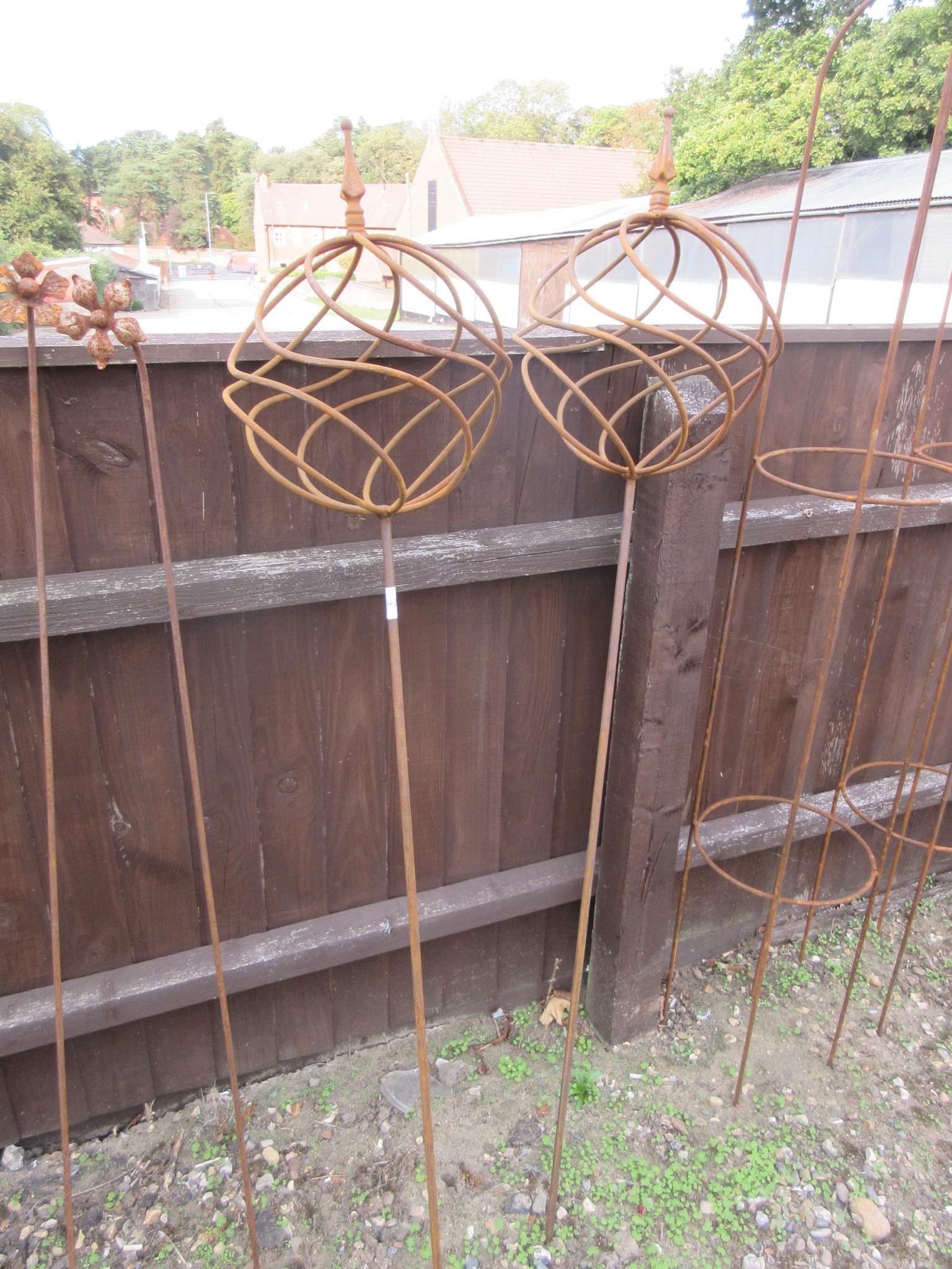 PAIR OF METAL GARDEN ORNAMENTS FORMED AS BALLS ON STICKS HEIGHT APPROX 150CM