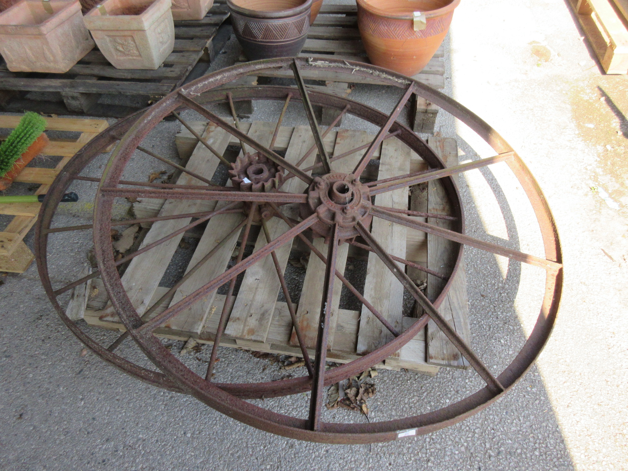 TWO VERY LARGE VINTAGE IRON WHEELS ONE NAMED FOR NICHOLSONS NEWARK NUMBERED 925X PROBABLY FROM
