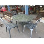LARGE METAL PATIO TABLE APPROX 121CM DIAMETER TOGETHER WITH FOUR MATCHING CHAIRS (ONE AF)