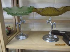 TWO GLASS DISHES SUPPORTED BY A PAIR OF SILVER PLATED LADIES