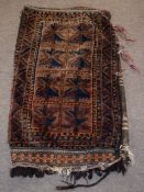 Large camel bag decorated on one side with geometric designs on a mainly brown and orange