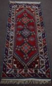 Late 20th century Caucasian style carpet with double gull border, central panel of three geometric