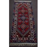 Late 20th century Caucasian style carpet with double gull border, central panel of three geometric