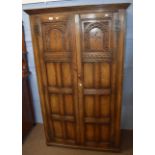Reproduction oak wardrobe with panel doors enclosing hanging space 1.06m wide