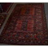 Large Caucasian style carpet multi gull border central panel of geometric designs mainly red field 2