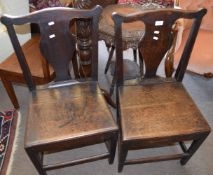 Pair of 18th century oak solid seat dining chairs, the plain supports joined all round by stretchers