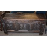 18th century oak coffer with three panel carved front on heavy stile feet 1.4m wide