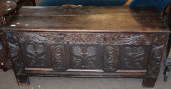 18th century oak coffer with three panel carved front on heavy stile feet 1.4m wide