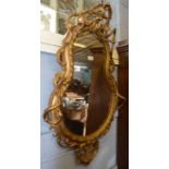 Victorian gilt and gesso wall mirror crested with birds foliage and fruit and C scroll moulded