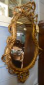 Victorian gilt and gesso wall mirror crested with birds foliage and fruit and C scroll moulded