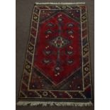 Caucasian small rug circa late 20th century central geometric pattern mainly red and green/brown