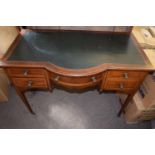 Edwardian mahogany desk with rexine inset, bowed central frieze with drawer flanked on either side