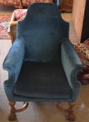 Oak framed blue upholstered armchair with wavy x-stretcher and front carved paw feet