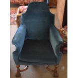 Oak framed blue upholstered armchair with wavy x-stretcher and front carved paw feet