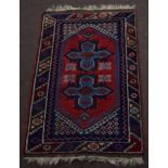 Small late 20th century Caucasian rug central cruciform design mainly red and blue field 117 x 75cm
