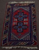 Small late 20th century Caucasian rug central cruciform design mainly red and blue field 117 x 75cm