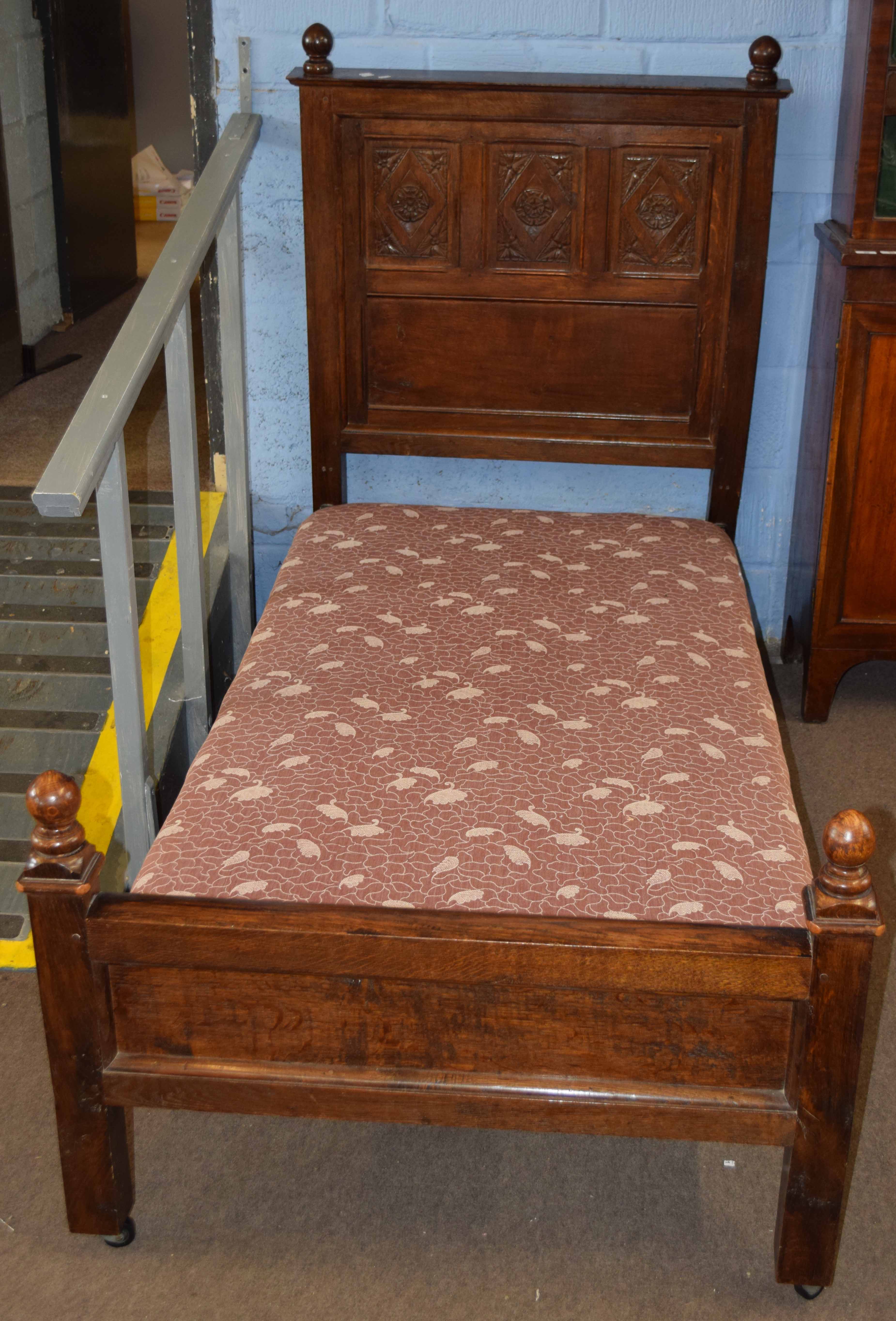 Pair of oak single bedsteads, three panel backs carved with Tudor rose designs (constructed from