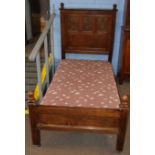 Pair of oak single bedsteads, three panel backs carved with Tudor rose designs (constructed from