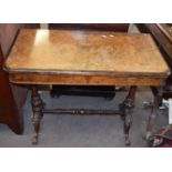 Victorian walnut card table with folding and swivelling top inlaid in the aesthetic manner raised on