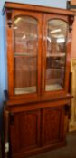 Victorian mahogany side cabinet, glazed top over panel doors enclosing cupboard on a plinth base