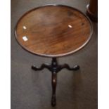 Early 19th century mahogany pedestal table, circular form with ring turned support terminating in