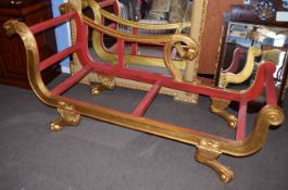 Reproduction gilded and painted chaise longue, the back rest and arm with carved birds head detail