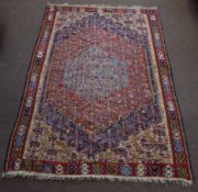 Wool embroidered Caucasian type carpet, central panel with pale blue lozenge and further red, blue