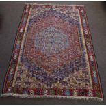 Wool embroidered Caucasian type carpet, central panel with pale blue lozenge and further red, blue