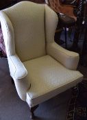 Georgian style wing armchair upholstered in patterned cream on short cabriole front supports Est 330