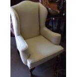 Georgian style wing armchair upholstered in patterned cream on short cabriole front supports Est 330