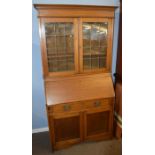 Edwardian bureau bookcase, inlaid with geometric panels and leaded glazed top enclosing fitted