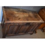 Oak coffer with three panel front and plain interior on stile feet 109cm wide