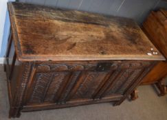 Oak coffer with three panel front and plain interior on stile feet 109cm wide