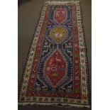 Caucasian large wool runner, double gull border, central panel of three interlinked lozenges with