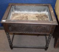 Oak planter of rectangular form with zinc lined interior, carved frieze on bobbin turned supports