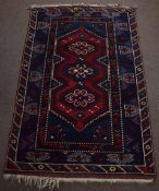 Late 20th century Caucasian wool rug, triple gull border, central panel of three interlinked